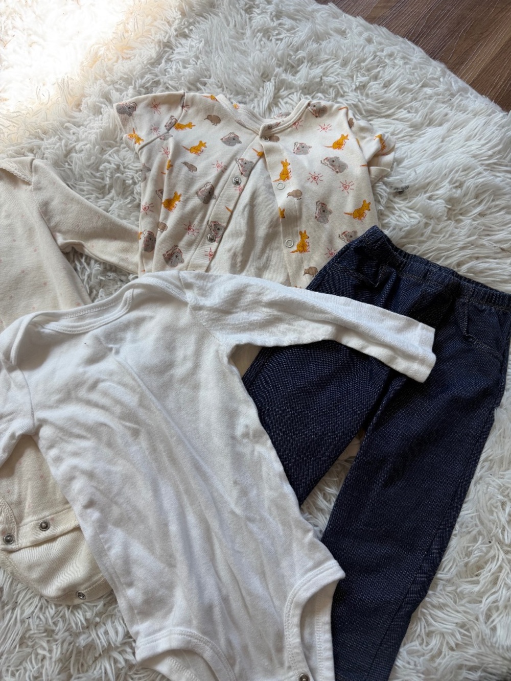 Three soft Carter's Neutral Cream & White Long-Sleeve Baby Bodysuits and pants s